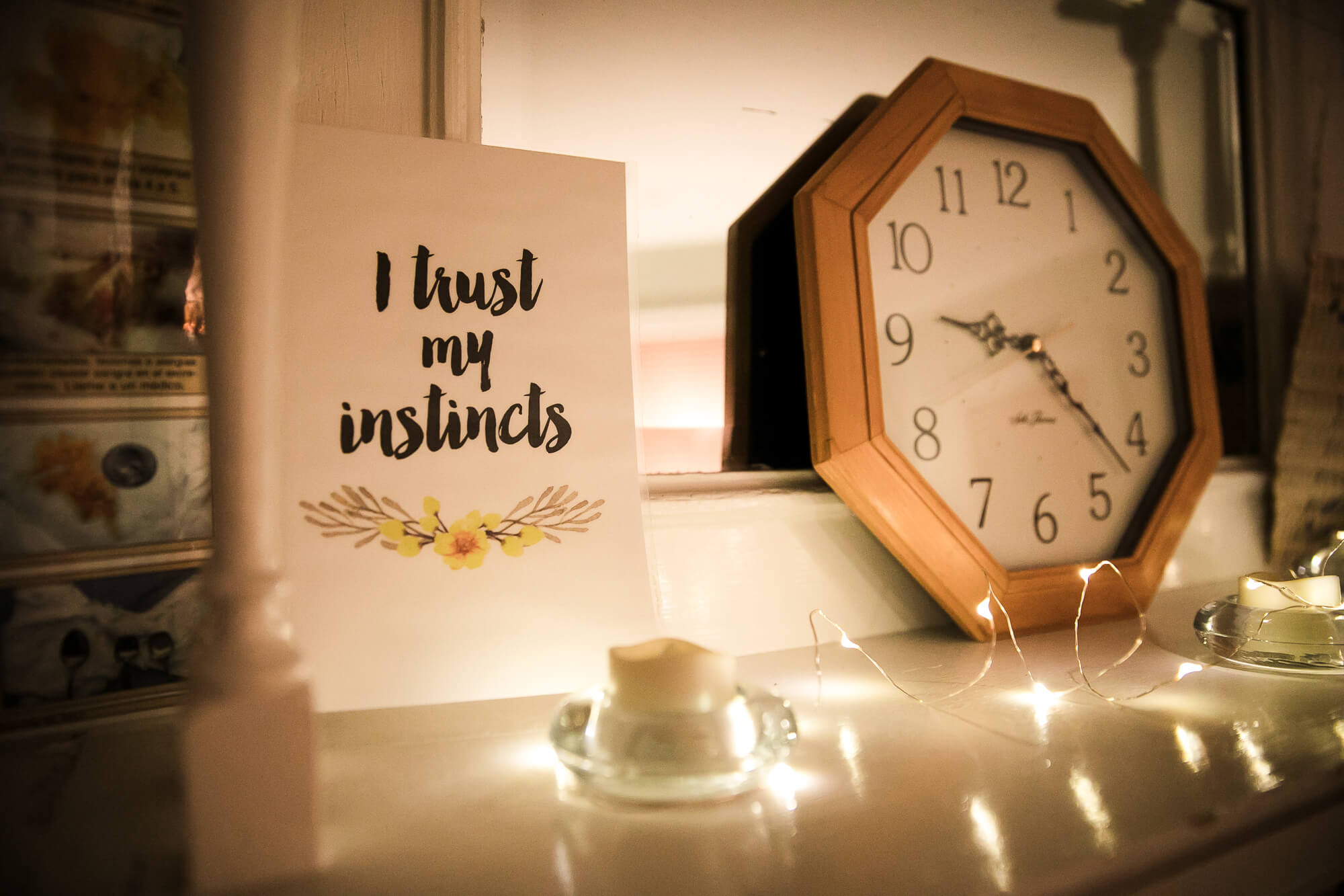 "I trust my instincts" card next to a wooden clock surrounded by white christmas lights, in a room at a Boston birthing center